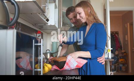 Loving husband communicates with his wife in the kitchen. Stock Photo