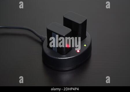 Close up of rechargeable lithium-ion battery charger on black table Stock Photo