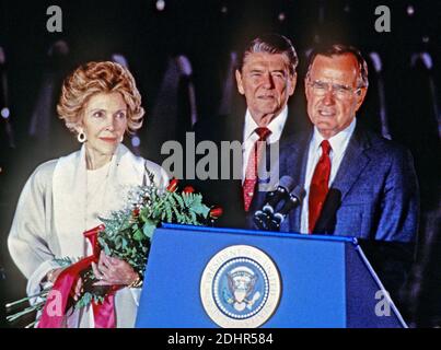 File photo : United States Vice President George H.W. Bush, right, introduces U.S. President Ronald Reagan, center, at a ceremony at Andrews Air Force Base, just outside of Washington, D.C. following the President's return from the Moscow Summit on June 3, 1988. First lady Nancy Reagan is at left.Credit: Arnie Sachs / CNP/ABACAPRESS.COM Stock Photo