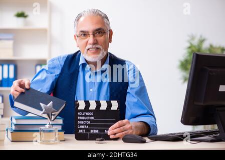 Old male author writing the screenplay Stock Photo