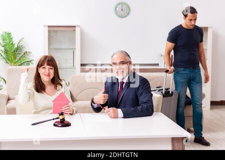 Old judge and young couple in divorcing concept Stock Photo