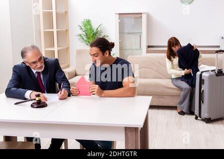 Old judge and young couple in divorcing concept Stock Photo