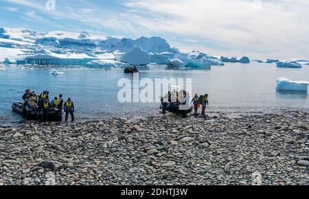 Ecotourists landing at Cuverville Island in the Errera Channel, on the western side of the Antarctic Peninsula Stock Photo