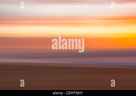 Golden sunset on the beach, an  abstract seascape with blurred panning motion in soft colors Stock Photo