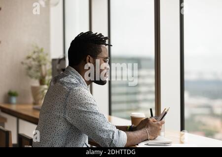 Young biracial man use smartphone gadget at home Stock Photo