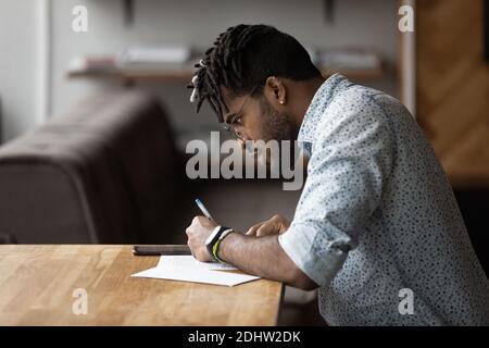 African American man make notes using cellphone Stock Photo