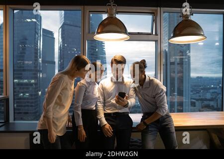 Happy multiracial colleagues have fun in office at night Stock Photo