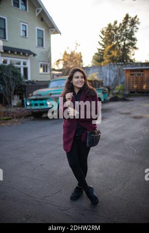 Beautiful woman smiling and standing in the street Stock Photo