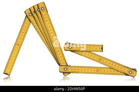 Yellow old wooden folding ruler, meter, isolated on white background with reflections.