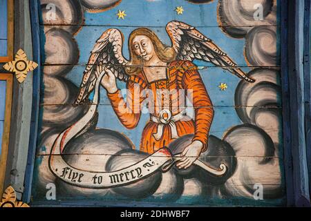 Painted ceiling showing a heavenly angel exhorting us to 'Flye to Mercy' in St Peter and St Paul parish church Muchelney in Somerset England