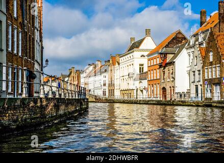 One of the lovely canals winding through the medieval city of Bruges in Belgium Stock Photo