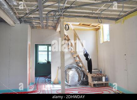 Close up on water floor heating system, interior walls insulation and soundproofing. Interior Room Construction. Stock Photo