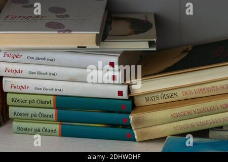 Hardcover books in Swedish piled on bookshelf, Moscow, 01.09.2020 Stock Photo