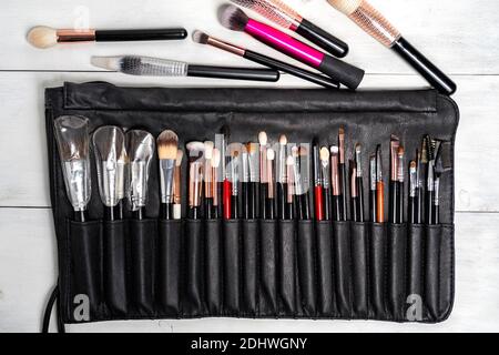 A set of black makeup brushes in a black leather case. makeup artist's working tool Stock Photo