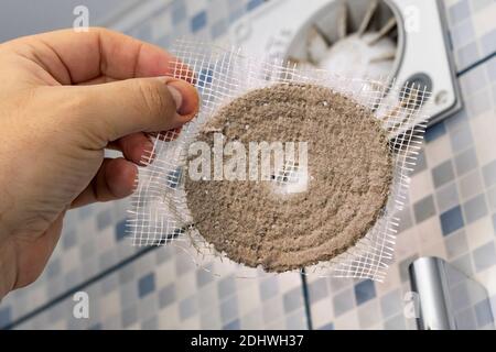 the master cleans the ventilation in the bathroom Stock Photo
