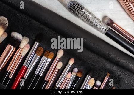 A set of black makeup brushes in a black leather case. makeup artist's working tool Stock Photo
