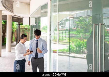 Two Business Colleagues Having Discussion new project business meeting outside office in an urban setting. Stock Photo