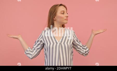 Young caucasian woman with outstretched hands like holding something isolated on pink background. Copy space. High quality photo Stock Photo