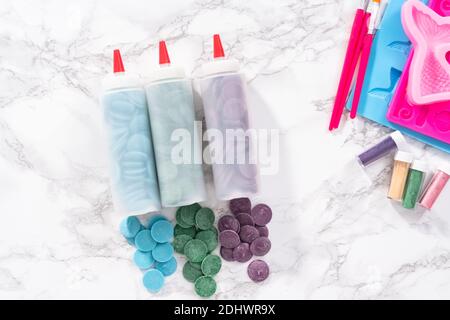 Flat lay. Ingredients to make chocolate mermaid molds from the chocolate chips. Stock Photo