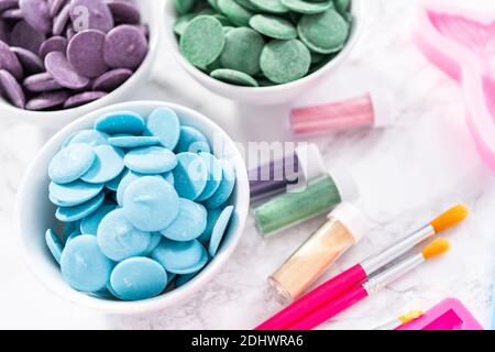 Flat lay. Ingredients to make chocolate mermaid molds from the chocolate chips. Stock Photo