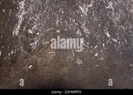 Abstract landscape of peeling blue paint on a rusty and stained metal surface with weld burns and traces of white and colored patches.Artistic texture Stock Photo