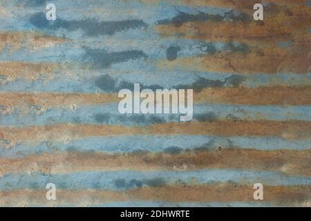 Blue painted sheet metal worn and dirty with rust. Texture background. Stock Photo