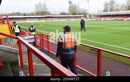 Crawley UK 12th December 2020 - A COVID-19 officer during the Sky Bet EFL League Two match between Crawley Town and Barrow AFC  at the People's Pension Stadium as fans were returning for the first time today - Editorial use only. No merchandising.  - for details contact Football Dataco  : Credit Simon Dack TPI / Alamy Live News Stock Photo