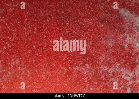 Weathered and stained textured background. scratched red wall with white spots. Stock Photo