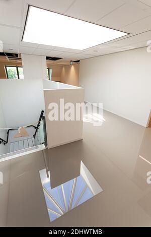LAREN, THE NETHERLANDS - MAY 16, 2012: An indoor hallway with a freshly added coating layer to create a synthetic cast floor installation. Stock Photo