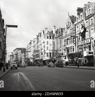 1960s, historical, street near Oxford Circus, Central London, England, UK, showing cars and trucks of the era. Retail stores of major travel companies, such as Quantas Airlines can be seen, as can an advertising display for Sandeman Port & Sherry. Stock Photo