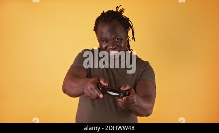 Focused african american black man with braided hair playing video games. High quality photo Stock Photo