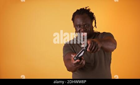 Focused african american black man with braided hair playing video games. High quality photo Stock Photo
