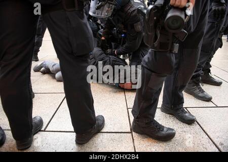 12 December 2020, Hessen, Frankfurt/Main: Police arrest a man who wanted to come to the court-prohibited lateral thinker rally at the main police station. Photo: Boris Roessler/dpa Stock Photo