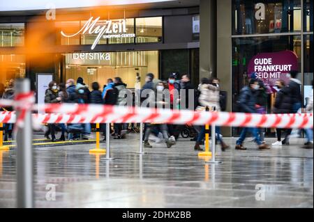 12 December 2020, Hessen, Frankfurt/Main: People walk along the Zeil shopping street past the 'MyZeil' shopping centre. Barrier tapes regulate access to the center. Photo: Andreas Arnold/dpa Stock Photo
