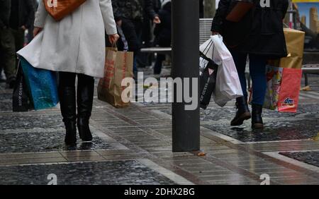 12 December 2020, Hessen, Frankfurt/Main: People walk down the Zeil shopping street with full shopping bags. Photo: Andreas Arnold/dpa Stock Photo