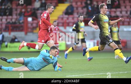 Crawley UK 12th December 2020 - Max Watters of Crawley goes through to score the opening goal past goalkeeper Joel Dixon of Barrow during the Sky Bet EFL League Two match between Crawley Town and Barrow AFC  at the People's Pension Stadium - Editorial use only. No merchandising.  - for details contact Football Dataco  : Credit Simon Dack Telephoto Images / Alamy Live News Stock Photo