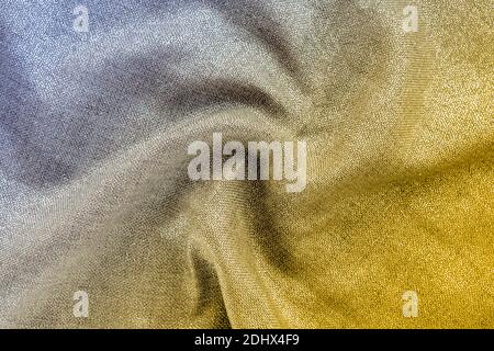 Shiny fabric with curl drape. Yellow and gray gradient, texture, background. Trendy colors 2021 Stock Photo