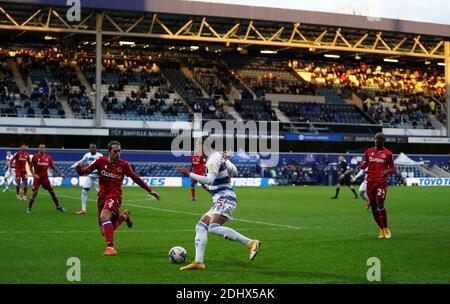 Queens Park Rangers' Niko Hamalainen runs at Reading's Lago Tomas Esteves (left) as fans can be seen watching from the stands during the Sky Bet Championship match at Loftus Road, London. Stock Photo