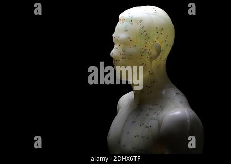 male acupuncture model against black background Stock Photo