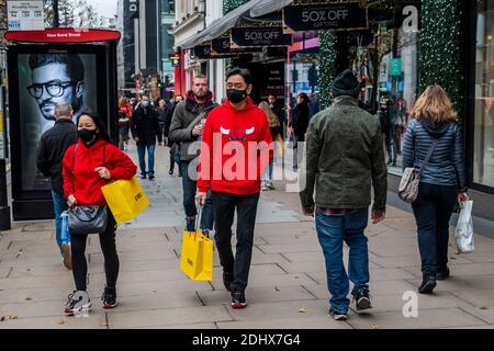 London, UK. 12th Dec, 2020. Oxford Street is busy and shoppers are out now the shops are open again. But these are still difficult times for retailers as they try to catch up after the second Coronavirus lockdown ends and Tier 3 for London is a distinct possibility. Credit: Guy Bell/Alamy Live News