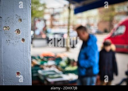 bullet holes outside wall after shooting in gang-related crime Stock Photo