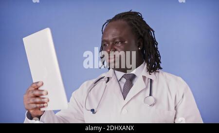 Young african american black man using tablet for medical research. High quality photo Stock Photo