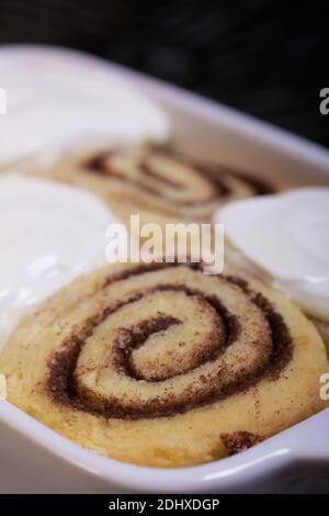 Baking cinnabons. The cinnamon rolls is in the baking dish. Close-up shot. Stock Photo