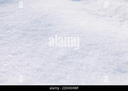 Background sparkling white snow in the sunlight Stock Photo