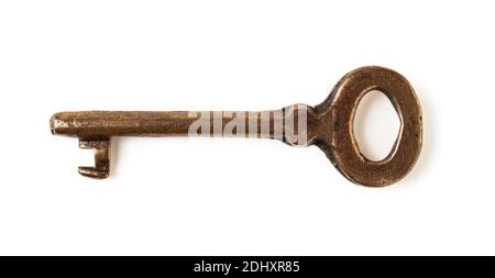 Metal shabby vintage key isolated on white background. Rusty yellow brown old key. Old fashioned design element. Directly above view. Stock Photo