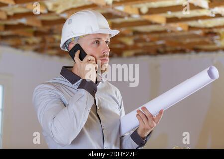 architect in development property holding plans and talking on telephone Stock Photo