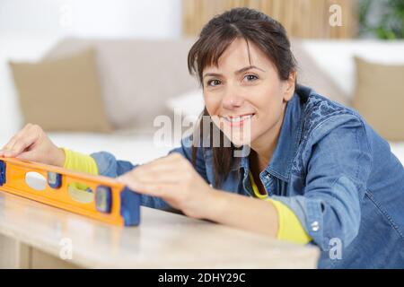 woman using spirit level in the home Stock Photo