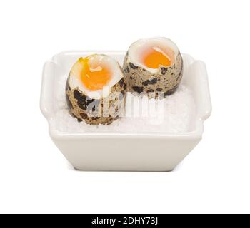 boiled quail eggs in a small dish on a white background Stock Photo