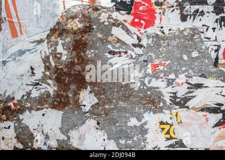 Grunge Background with Old Torn Posters. Multicolor texture. Stock Photo