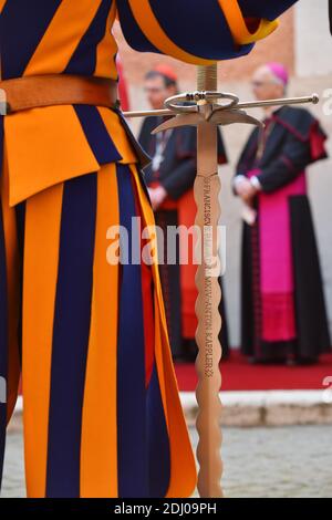 The Vatican's Swiss Guards swore in 23 new recruits on May 6, 2016 at the Vatican. The new recruits joined their ranks in an elaborate swearing-in ceremony . The ceremony is held each May 6 to commemorate the 147 Swiss Guards who died protecting Pope Clement VII during the 1527 Sack of Rome. Then each new recruit grasped the corps' flag and, raising three fingers in a symbol of the Holy Trinity, swore to uphold the Swiss Guard oath to protect pope Francis and his successors. The Swiss Guard, founded in 1506, consists of 100 volunteers who must be Swiss nationals, Catholic, single, at least 174 Stock Photo